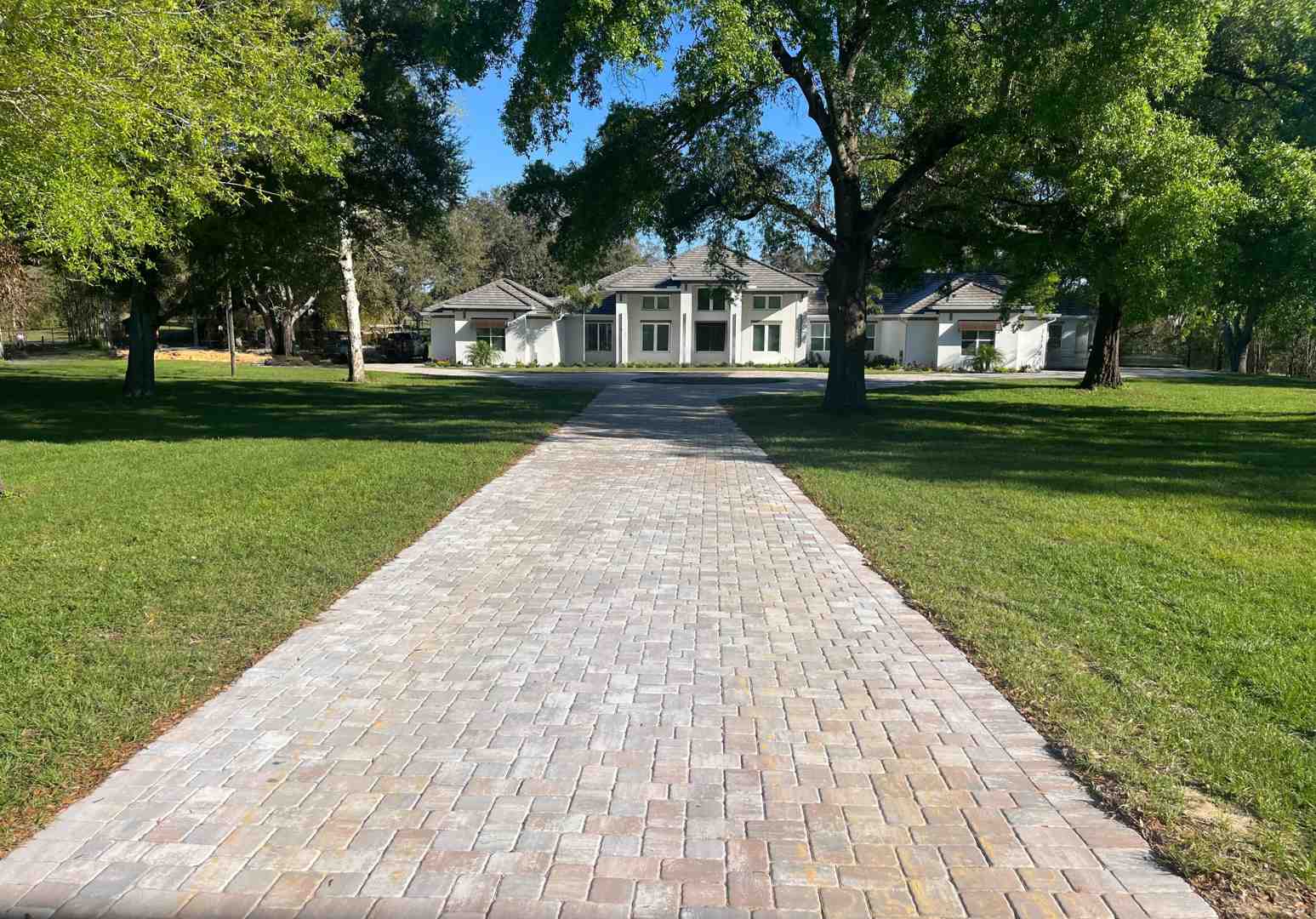 Image of a lawn mower easily moving along a crisp paver edge - edge flower bed ideas