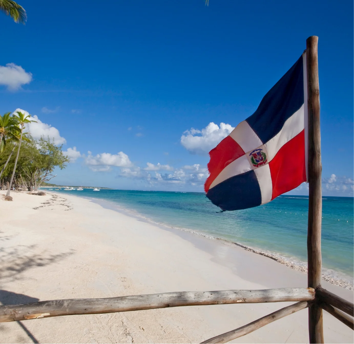 White-sand beach with Dominican Republic flag waving in the breeze
