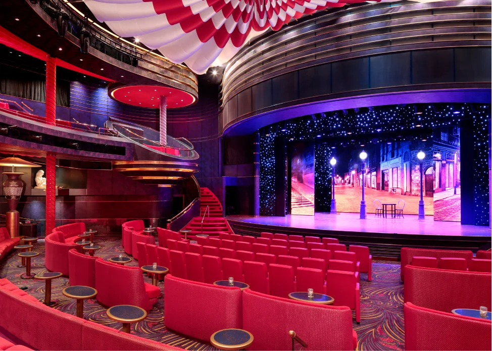 Ship’s theater and entertainment lounge illuminated in red and gold