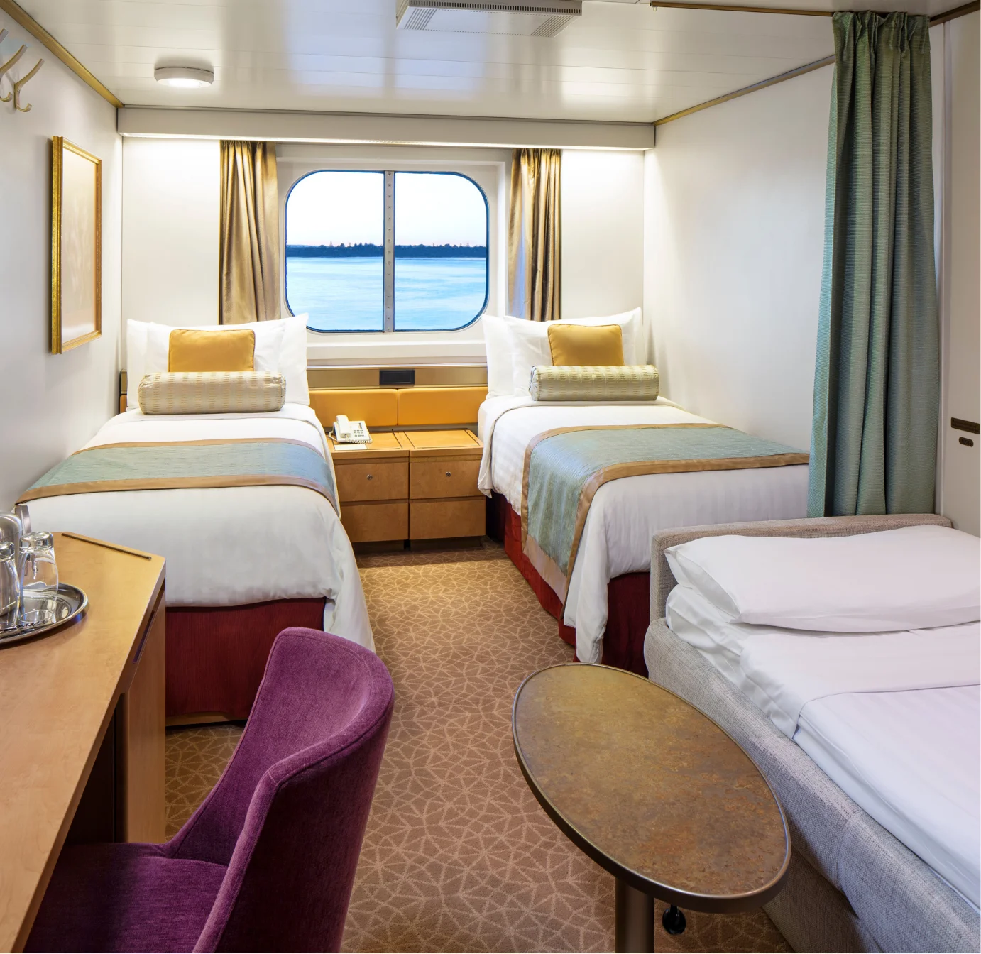 Ocean-view room with twin beds and porthole