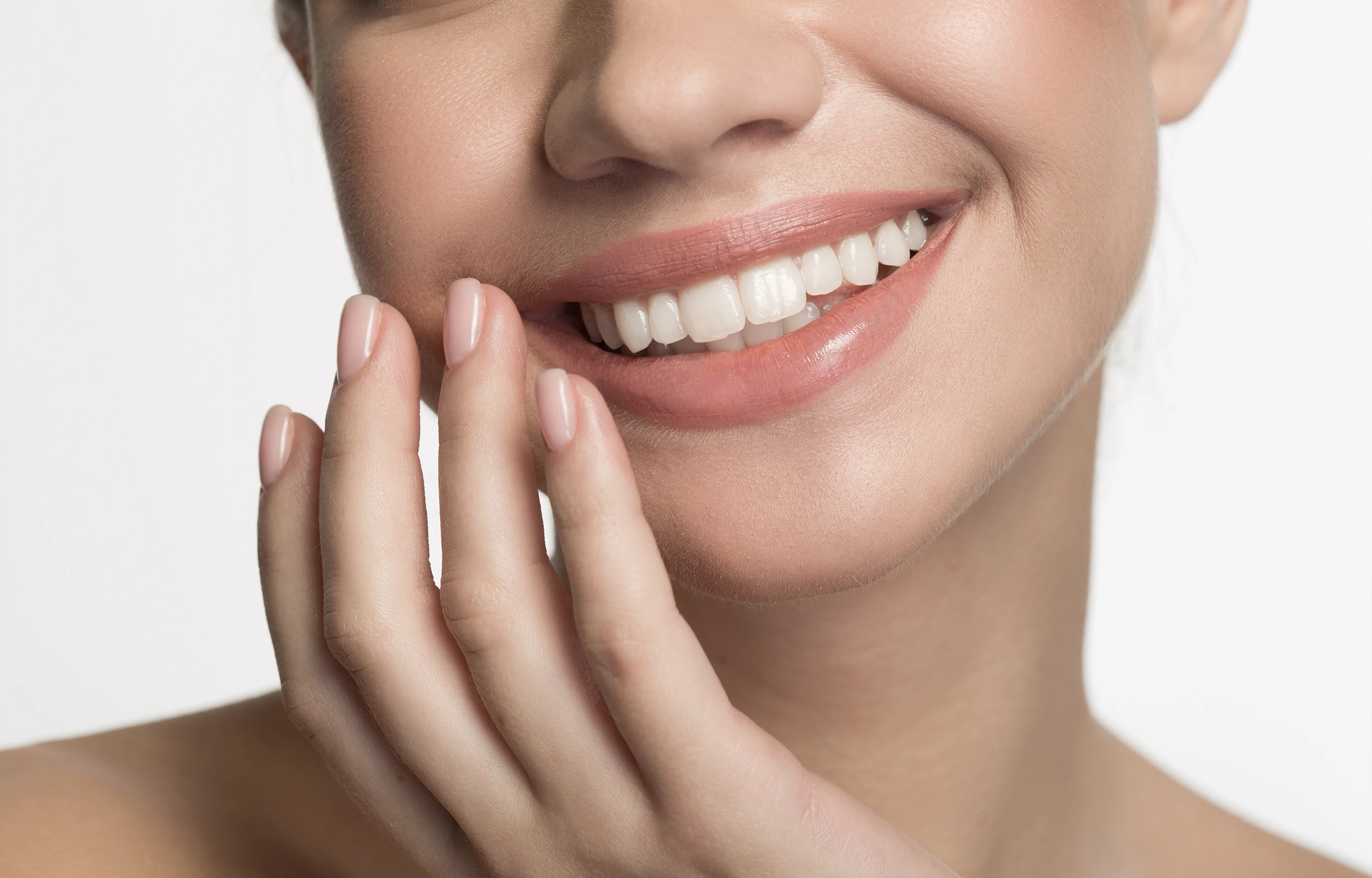 A woman smiling with her hand on her face