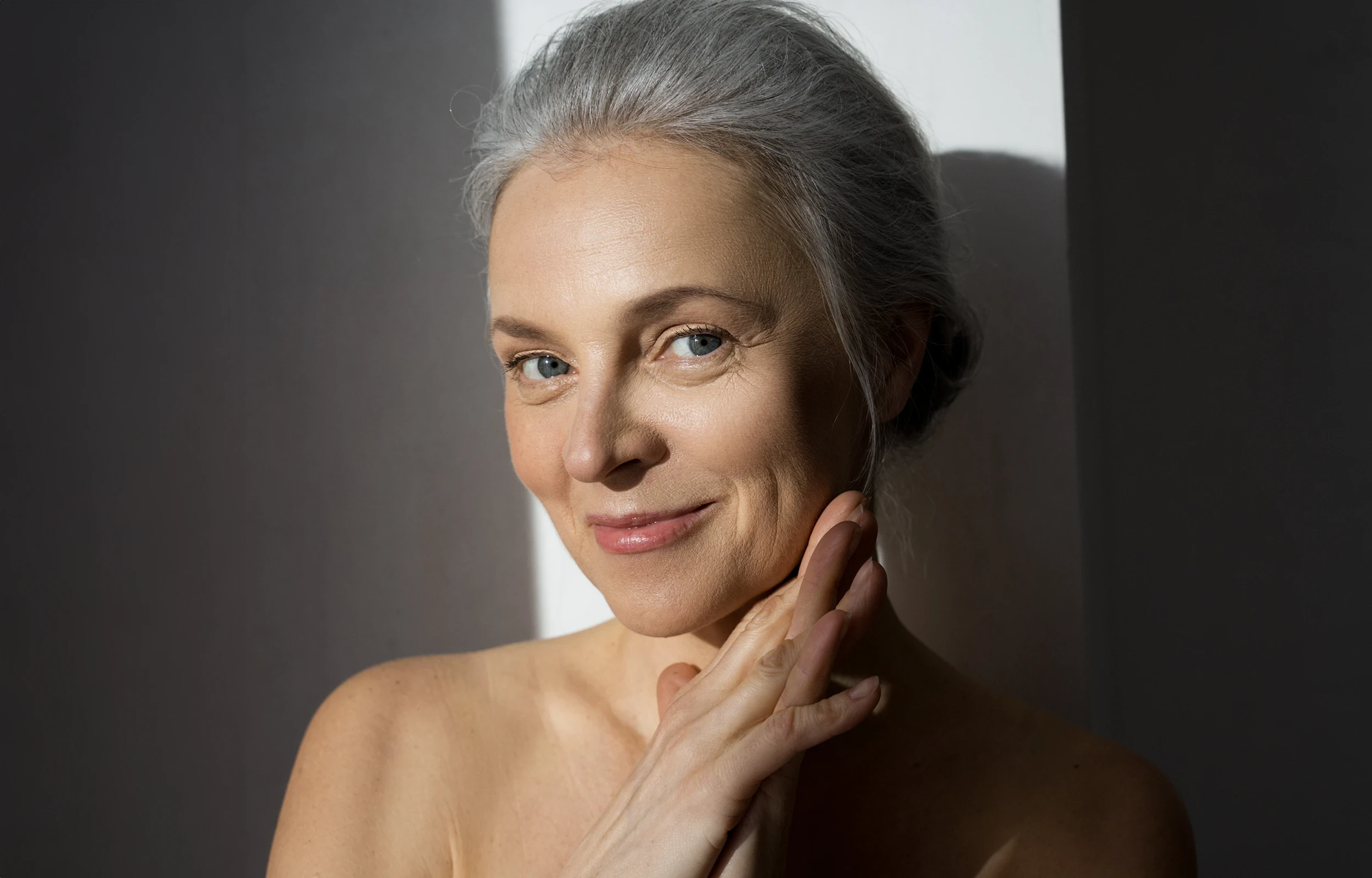 A woman smiling with her hands on her face