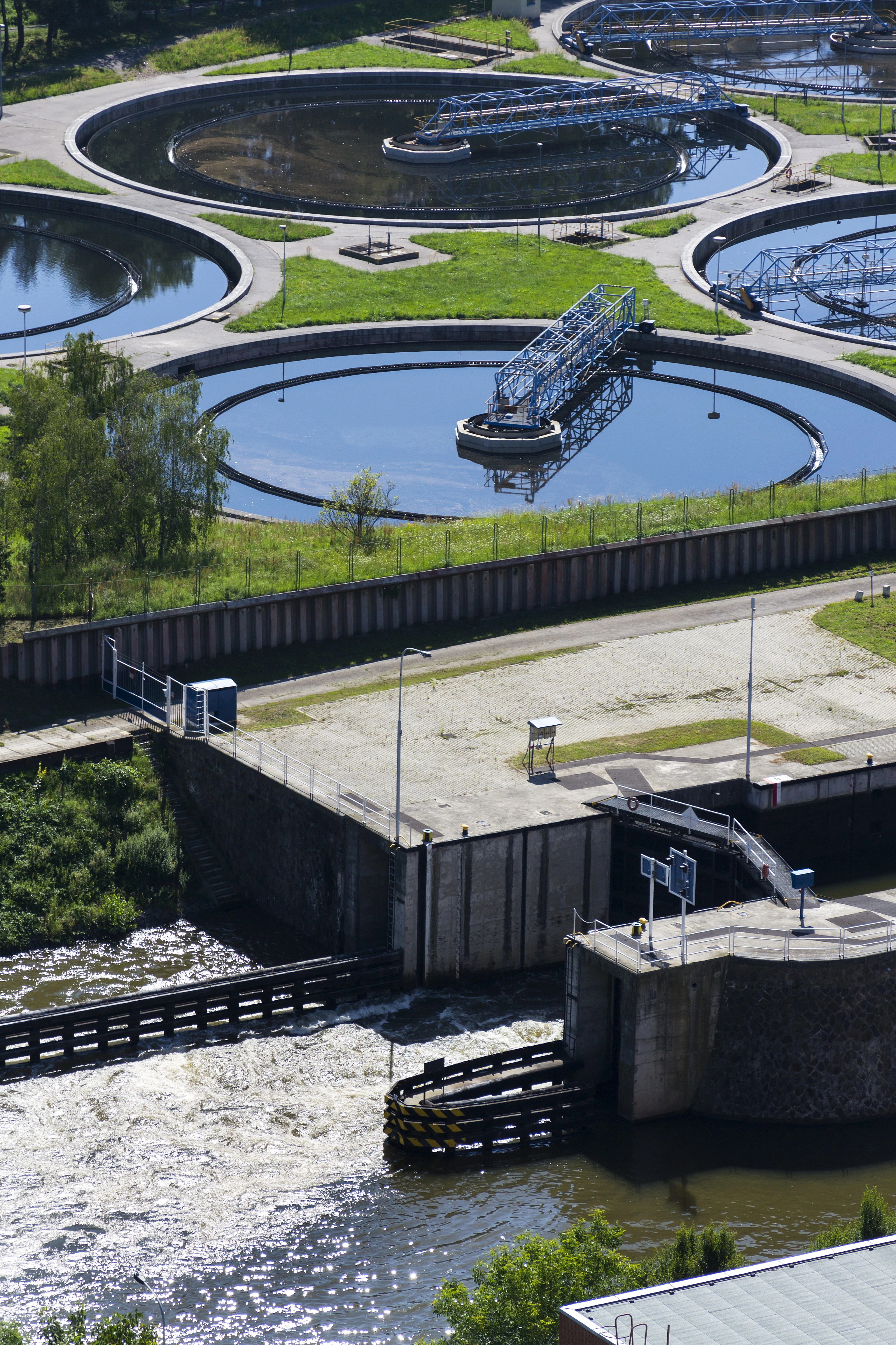 Aerial view of a modern water treatment facility with circular clarifiers, illustrating industrial dosing and process engineering applications.