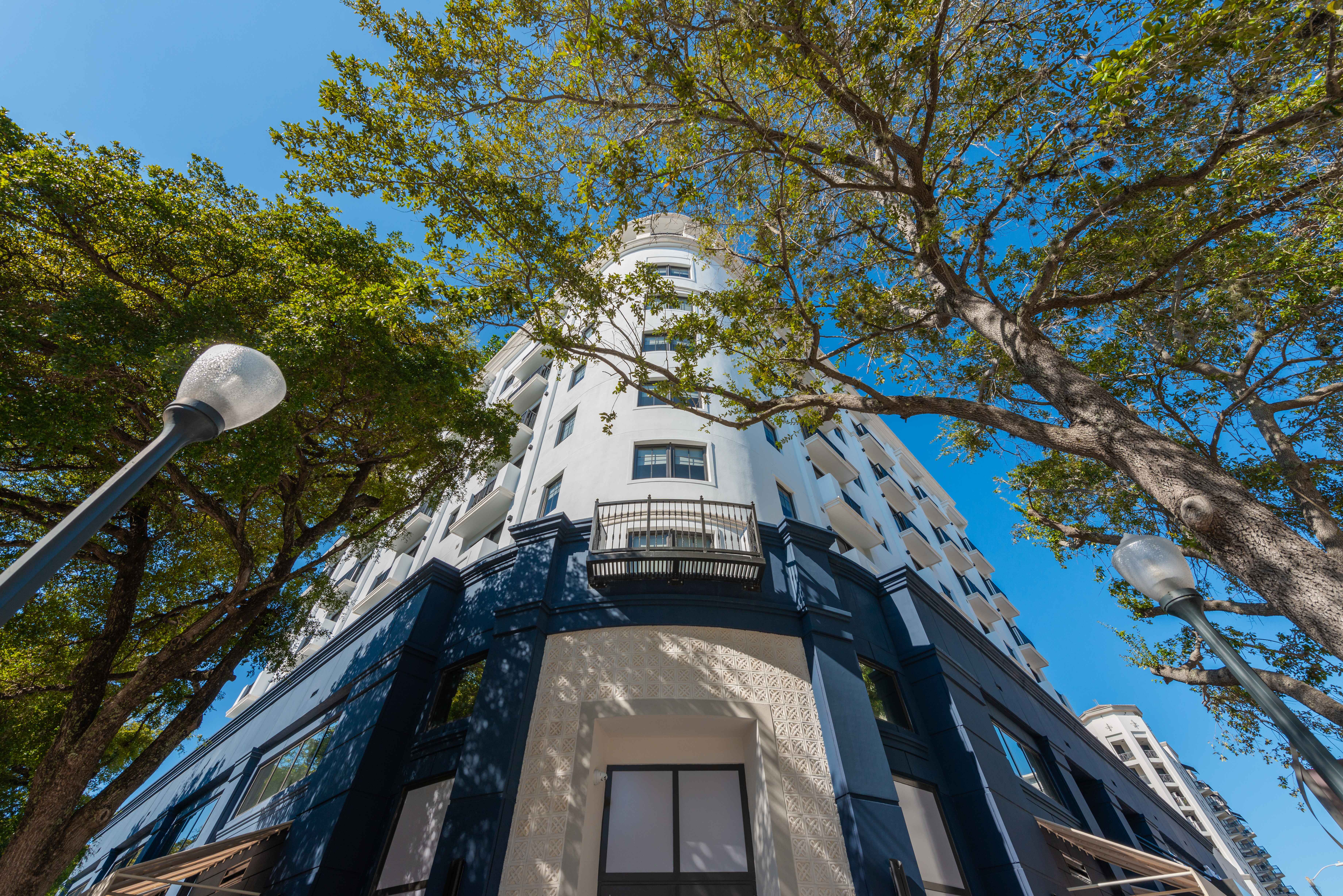 Low-angle view of The Avenue Coral Gables building exterior.