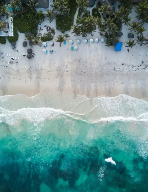 Aerial view of a luxury white sand beach in Tulum, Mexico, an ideal destination for strategic corporate retreats and team alignment.