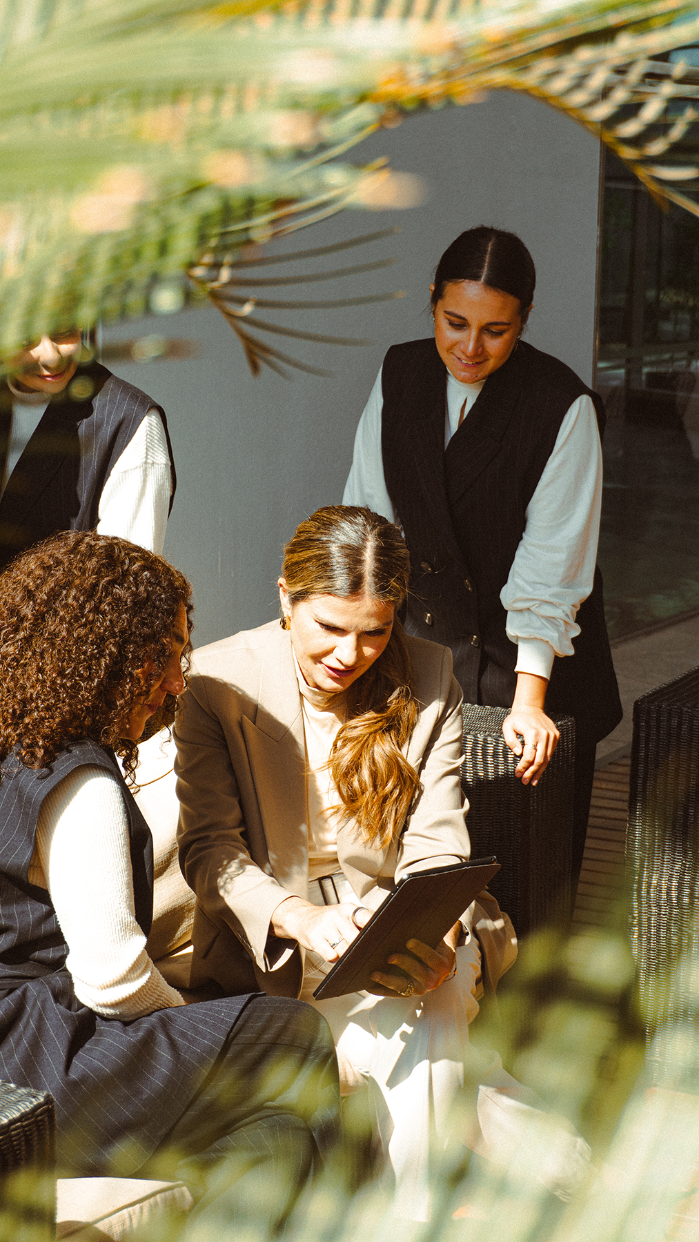 Photo of Marina and team checking a tablet together.