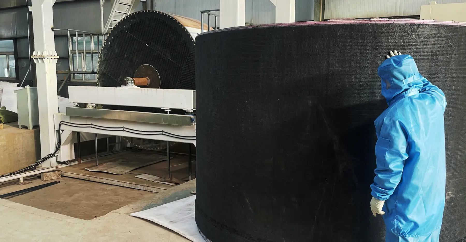 One of Max Graphite's employees inspecting CFC products in the factory