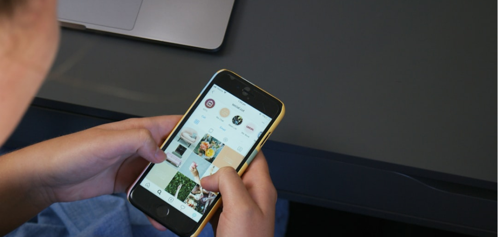 Close-up of hands holding a smartphone displaying content.