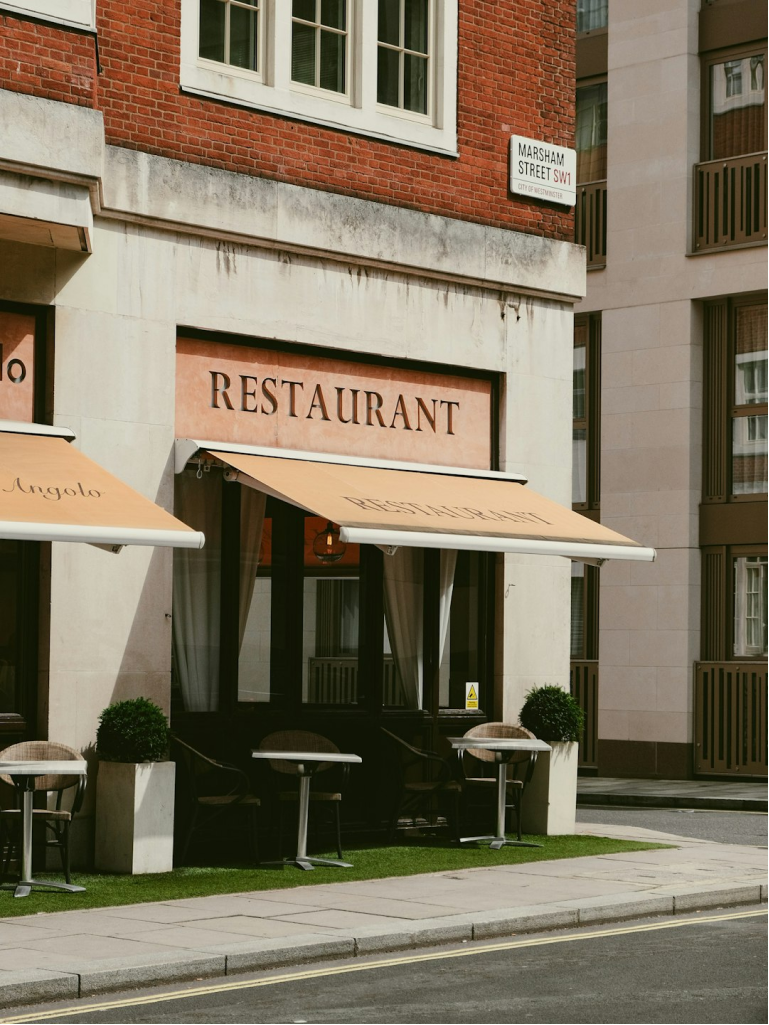 Grayscale photograph of a building facade with signage.
