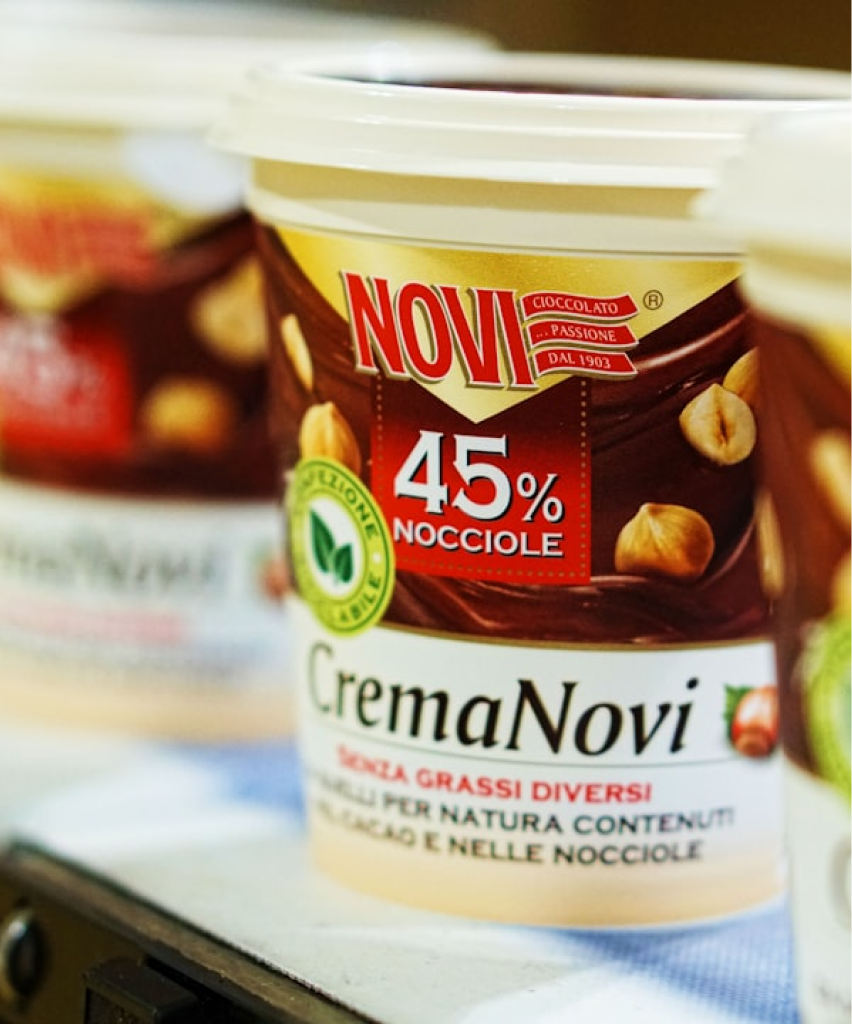 Grayscale photograph of a product container with text and branding.