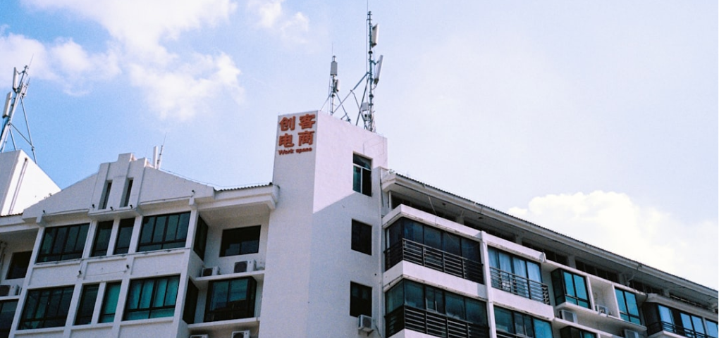 Image of a modern building exterior with multiple floors and windows.