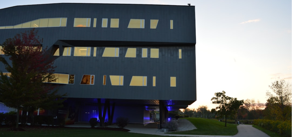 Image of a modern building with unique architectural features and trees.