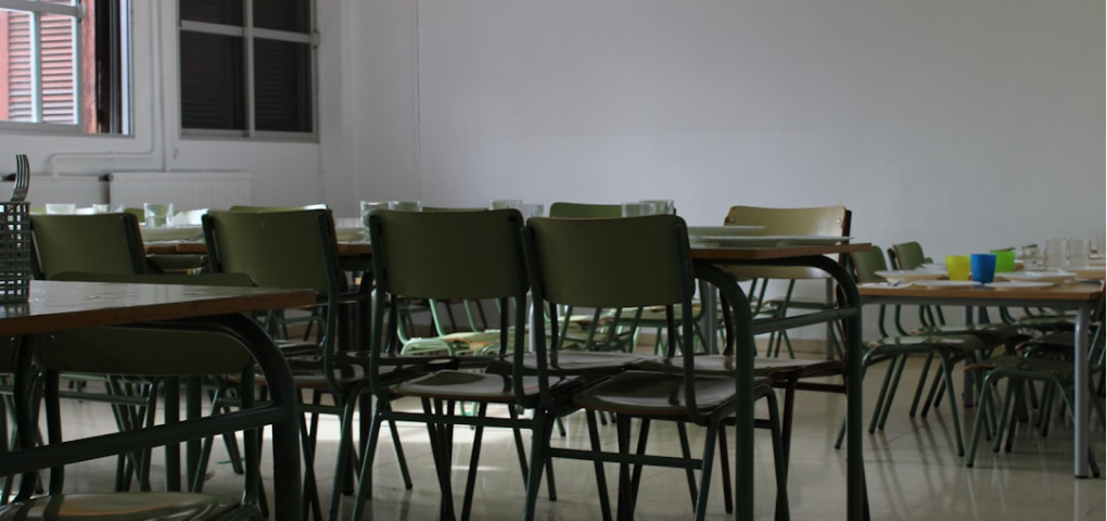 Image of an office meeting room with tables and chairs.
