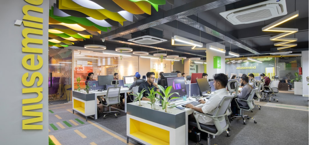 Image of a modern office interior with people working at desks.