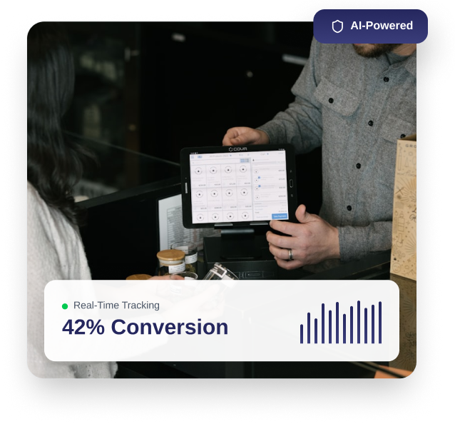 Person holding a tablet displaying a dashboard with conversion tracking data, showing 42% conversion rate with a bar graph and real-time tracking note.
