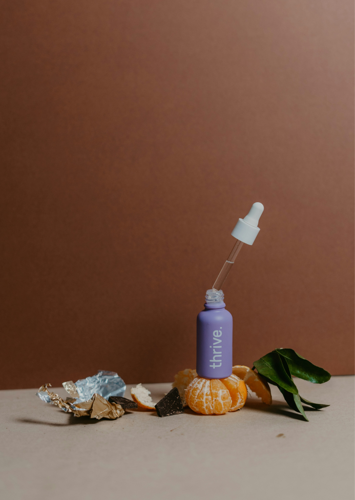 Product image of a bottle with a dropper and pumpkin.