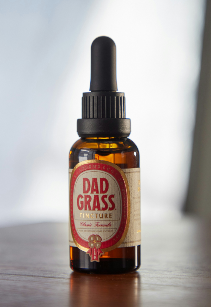 Black and white photograph of a dropper bottle with a label.