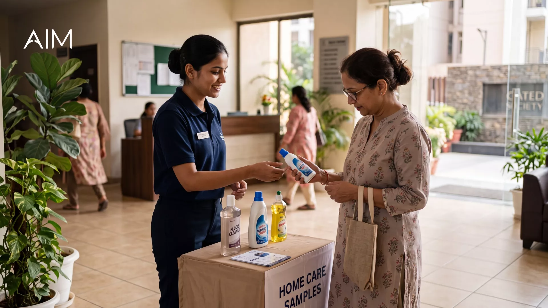 Promoter at a Home Care Samples table handing a product to a woman in a building lobby