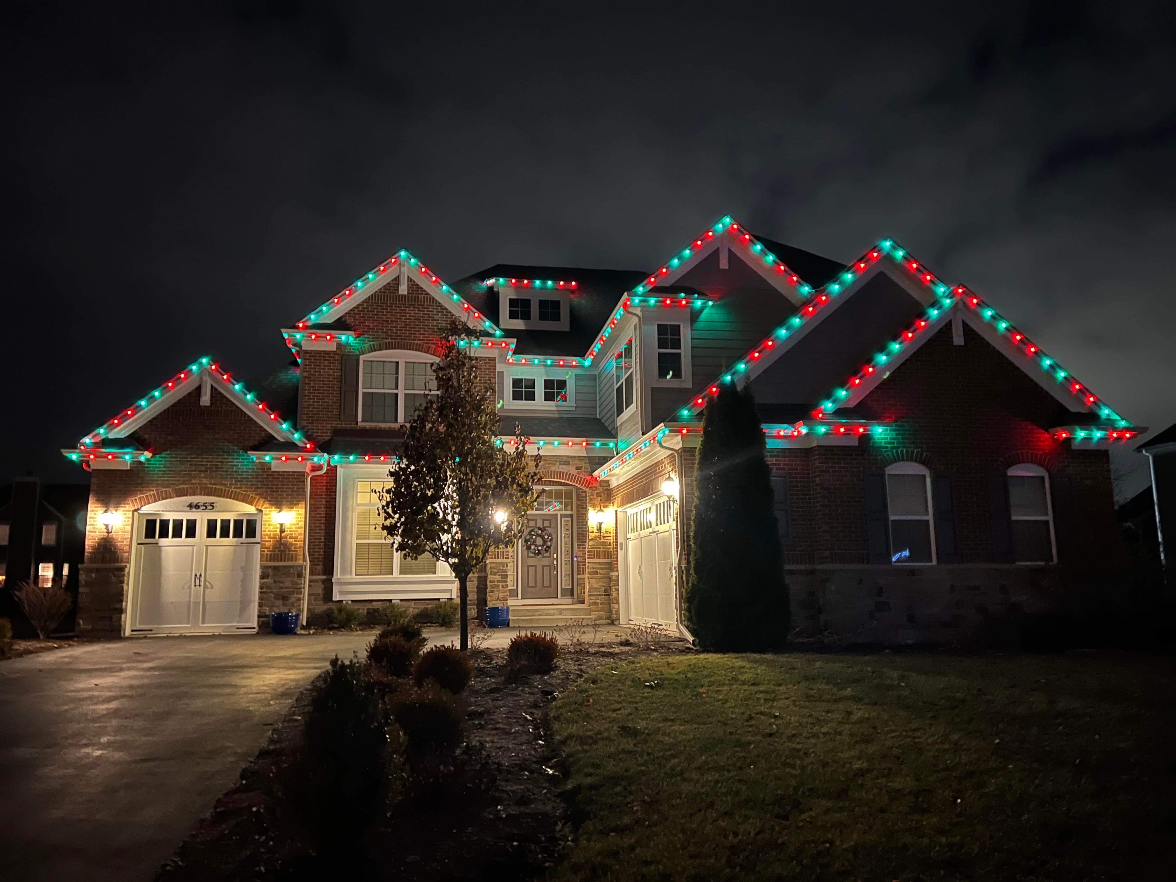 A house decorated with different colored lights.