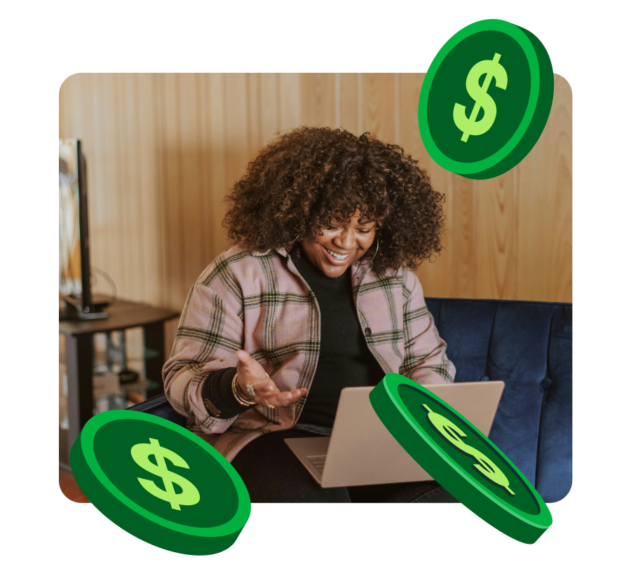 Smiling woman with curly hair using a laptop seated on a blue couch with floating green dollar coins around her.