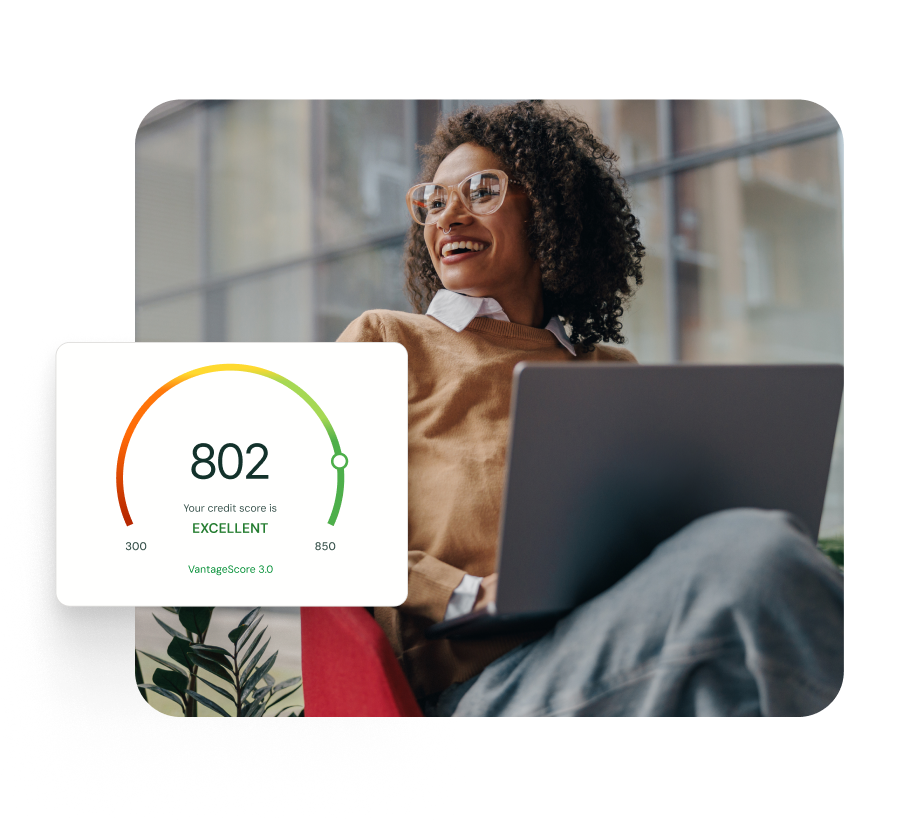 A happy professional woman working sitting with her laptop with a credit score of 802 rated as excellent displayed 