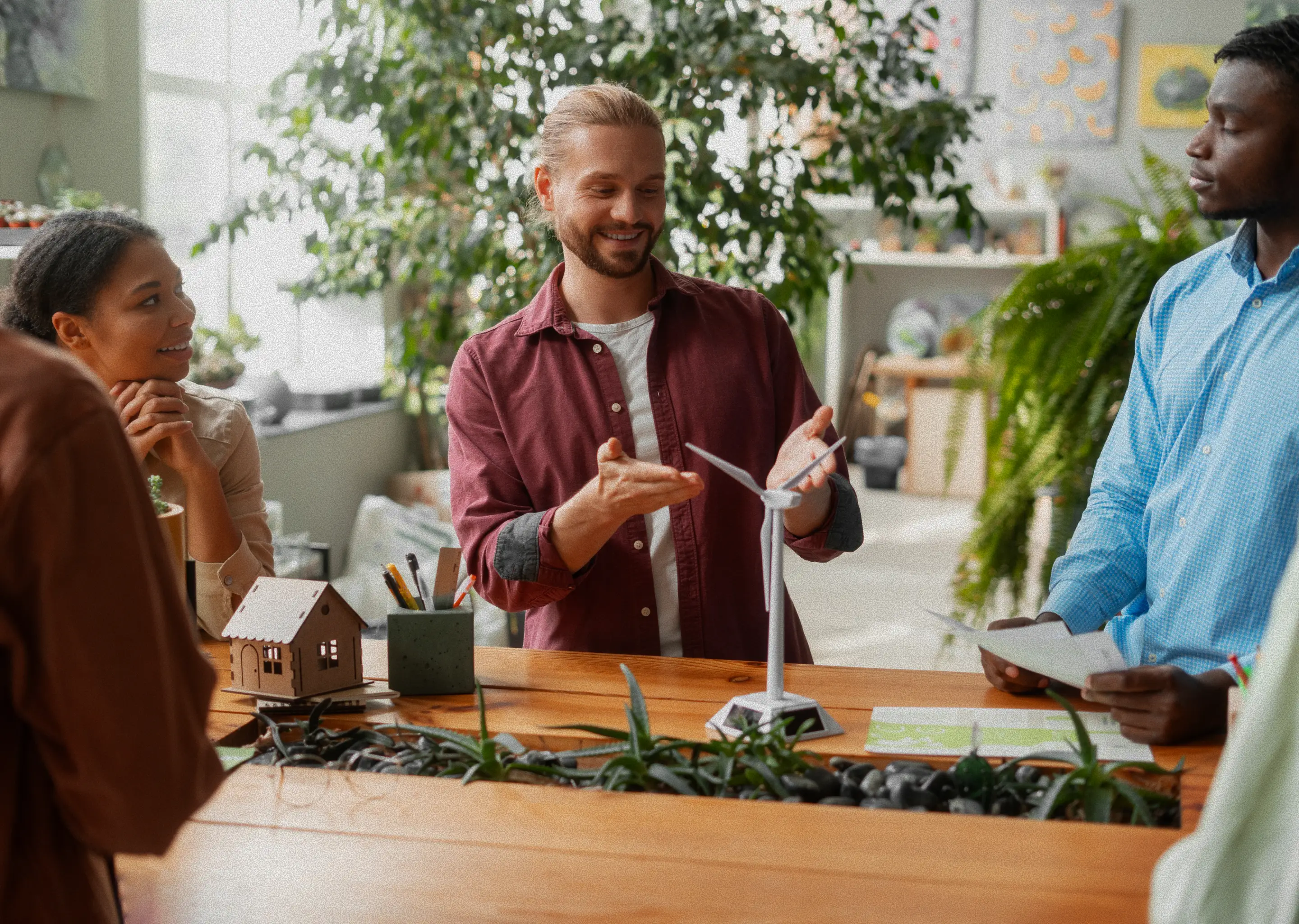 Student explaining a project model to peers during a group study activity.