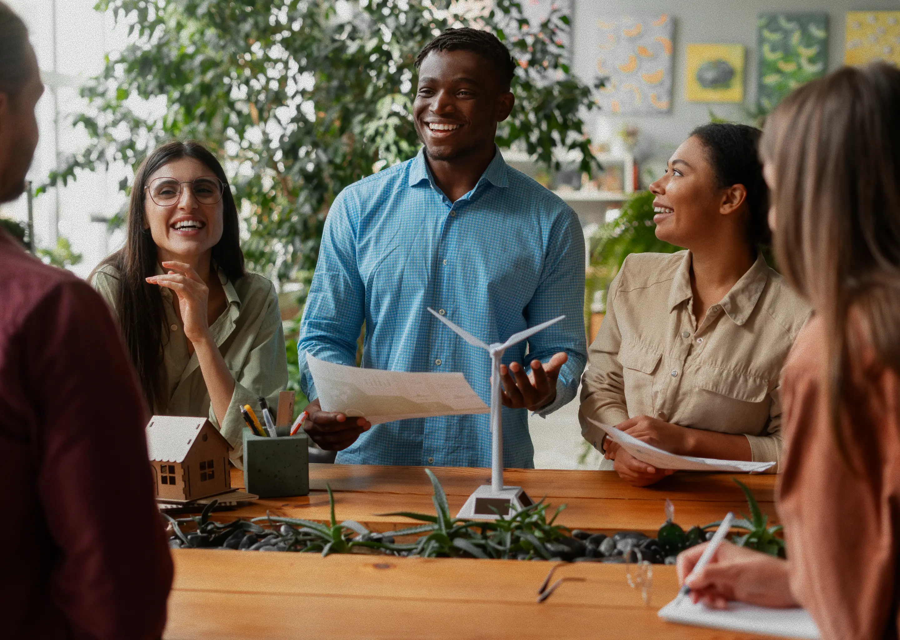 Group of students collaborating on a project, sharing ideas around study models.