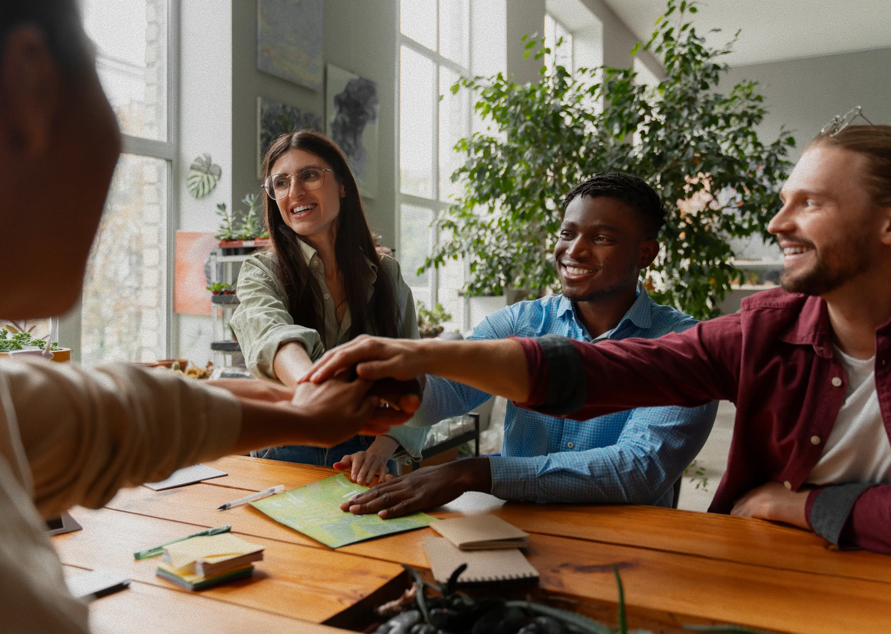 Students clasping hands in a team gesture of encouragement and support.