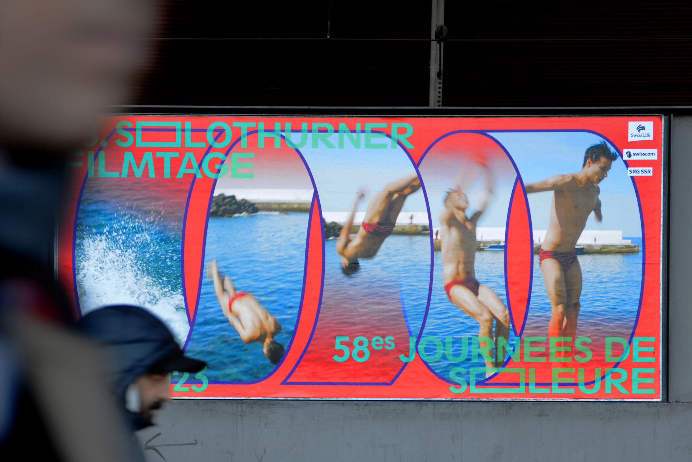 Poster showing a sequence of a man in red swim trunks diving into water, with text promoting the 58th Solothurn Film Festival.