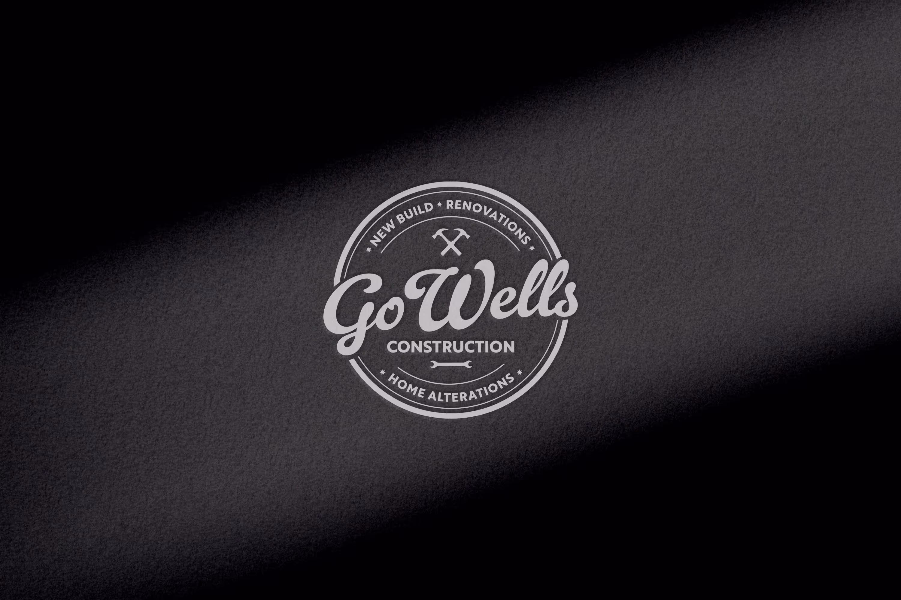 Go Wells Construction logo with crossed hammer and wrench icons and text: New Build, Renovations, Home Alterations.