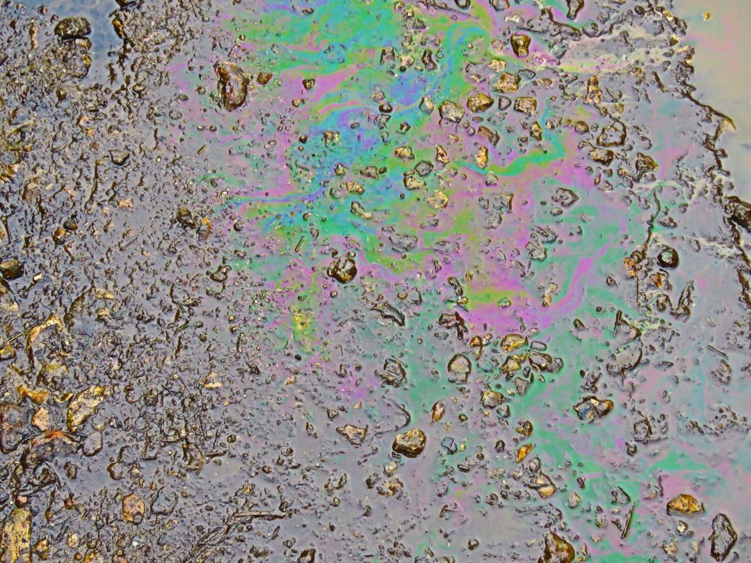 Ölflecken auf dem Plaster und es wird entfernt mit einem Hochdruckriniger.