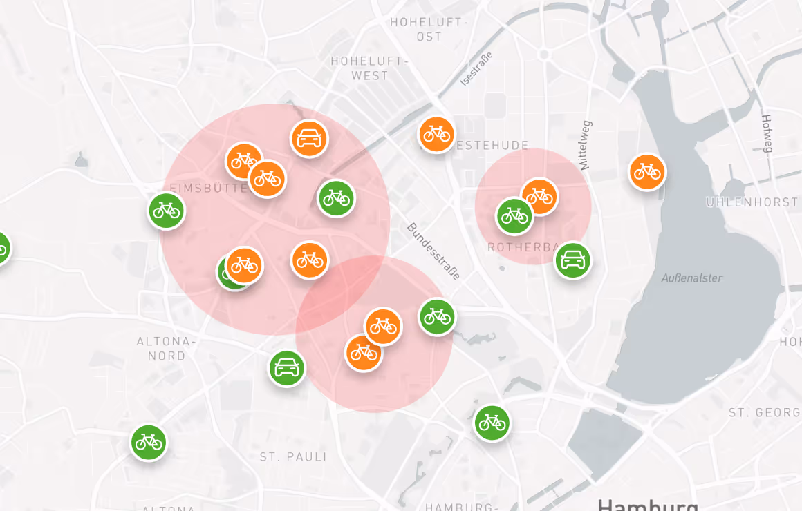 Map of Hamburg with orange and green bike and car icons clustered in various locations and three red translucent circles highlighting some areas.