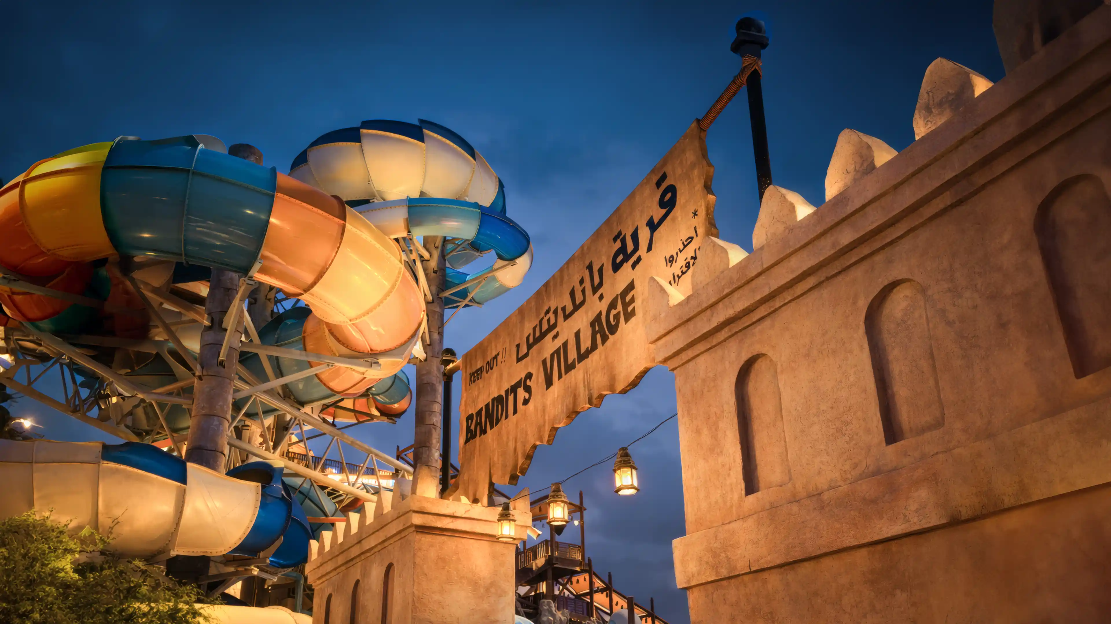 Nighttime view of the entrance of Yas Waterworld's new expansion, designed by LIMAH