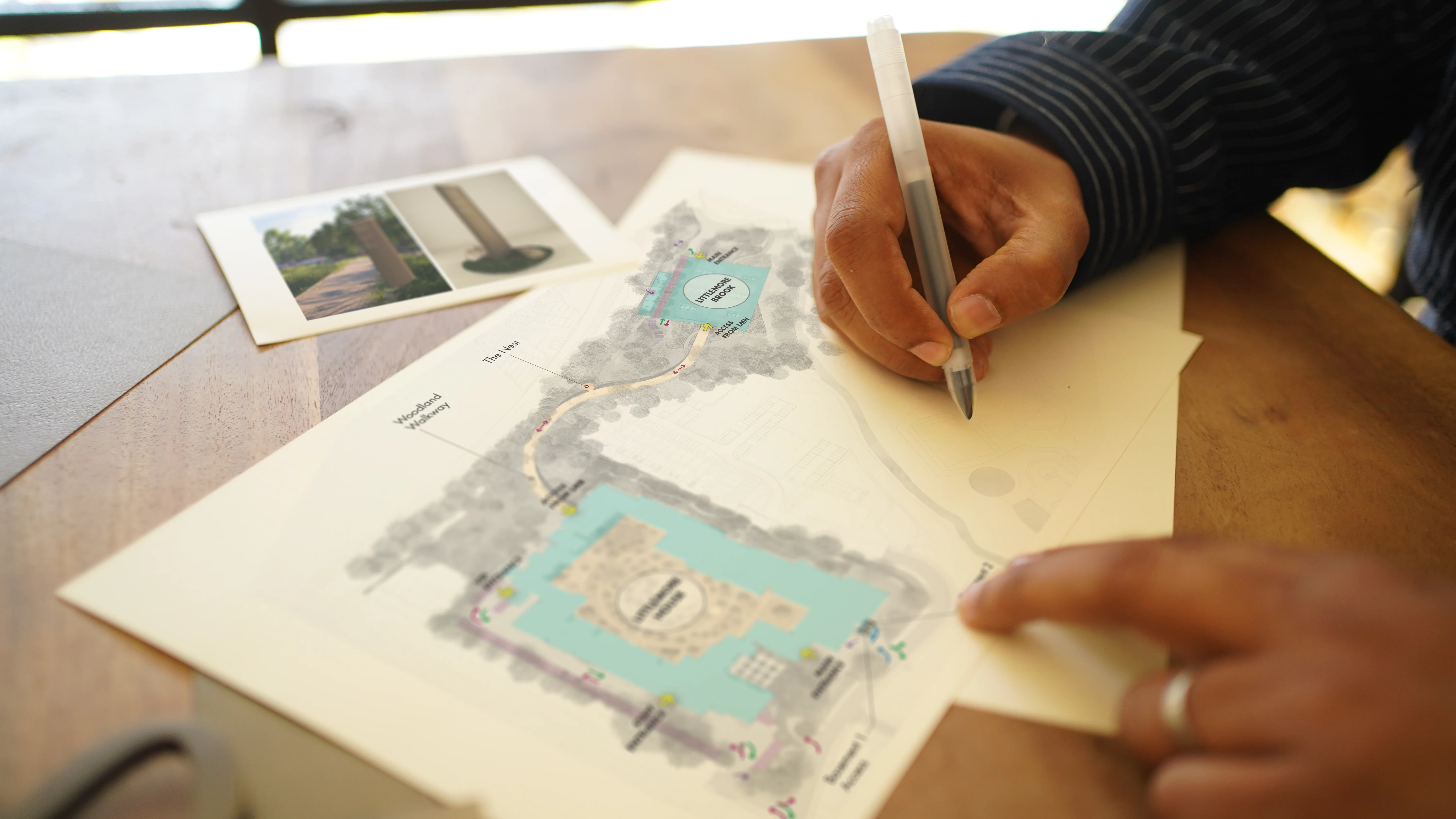 LIMAH designer reviewing early wayfinding and user experience strategy sketches during the design process