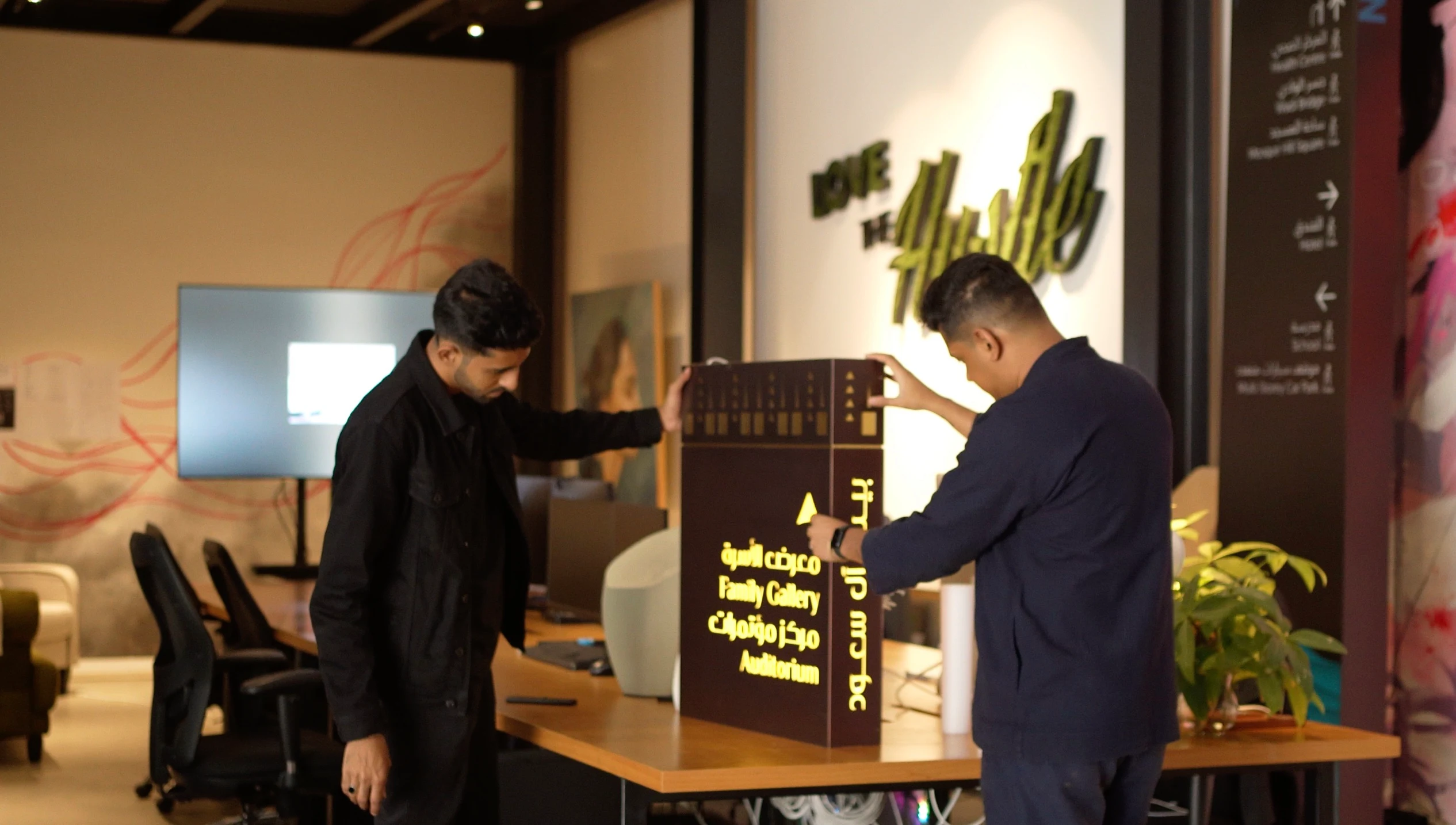 LIMAH team reviewing and interacting with a signage sample