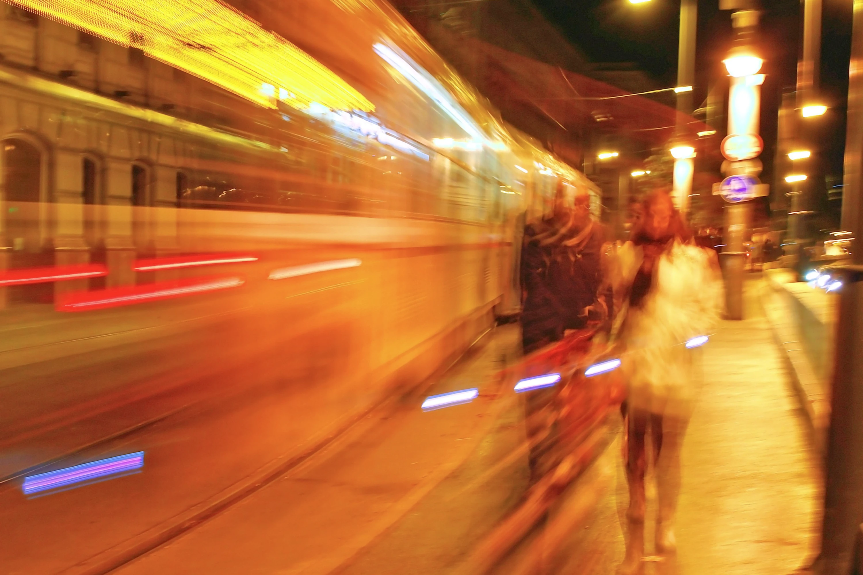 Vivid long exposure of a busy street at night highlighting motion trails.