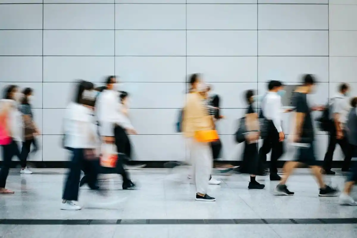 People walking through a busy environment during their daily commute