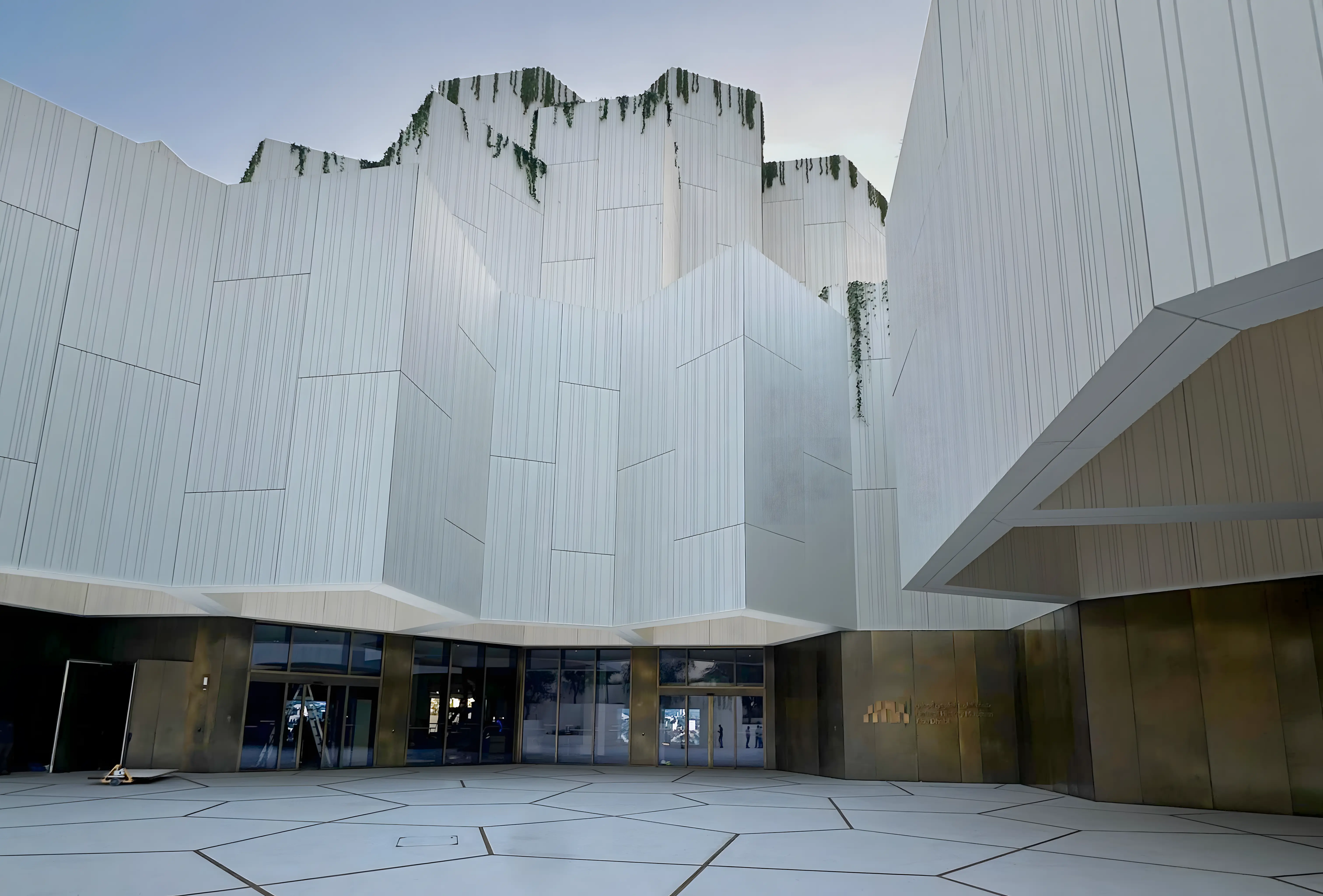 Entrance to the Natural History Museum Abu Dhabi featuring integrated architectural and visitor wayfinding design.