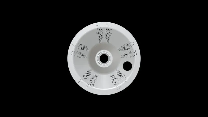 White circular vent cover with symmetrical perforated patterns and a central hole, set against a black background.
