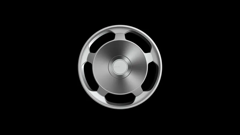 Silver car steering wheel with a circular central hub on a black background.