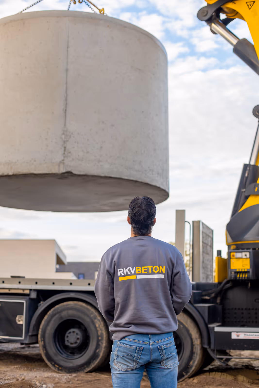 Levering van grote betonnen put via kraan op vrachtwagen door RKV Beton