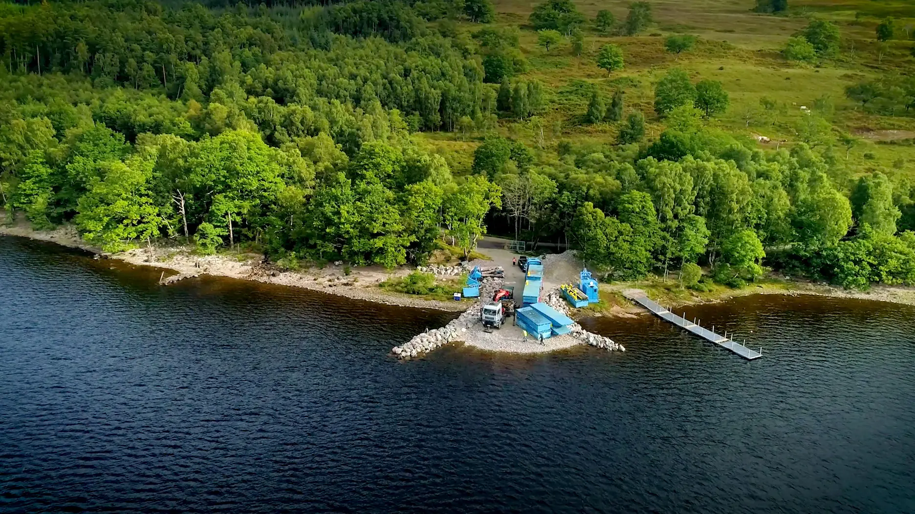 A large body of water with a dock and a boat.