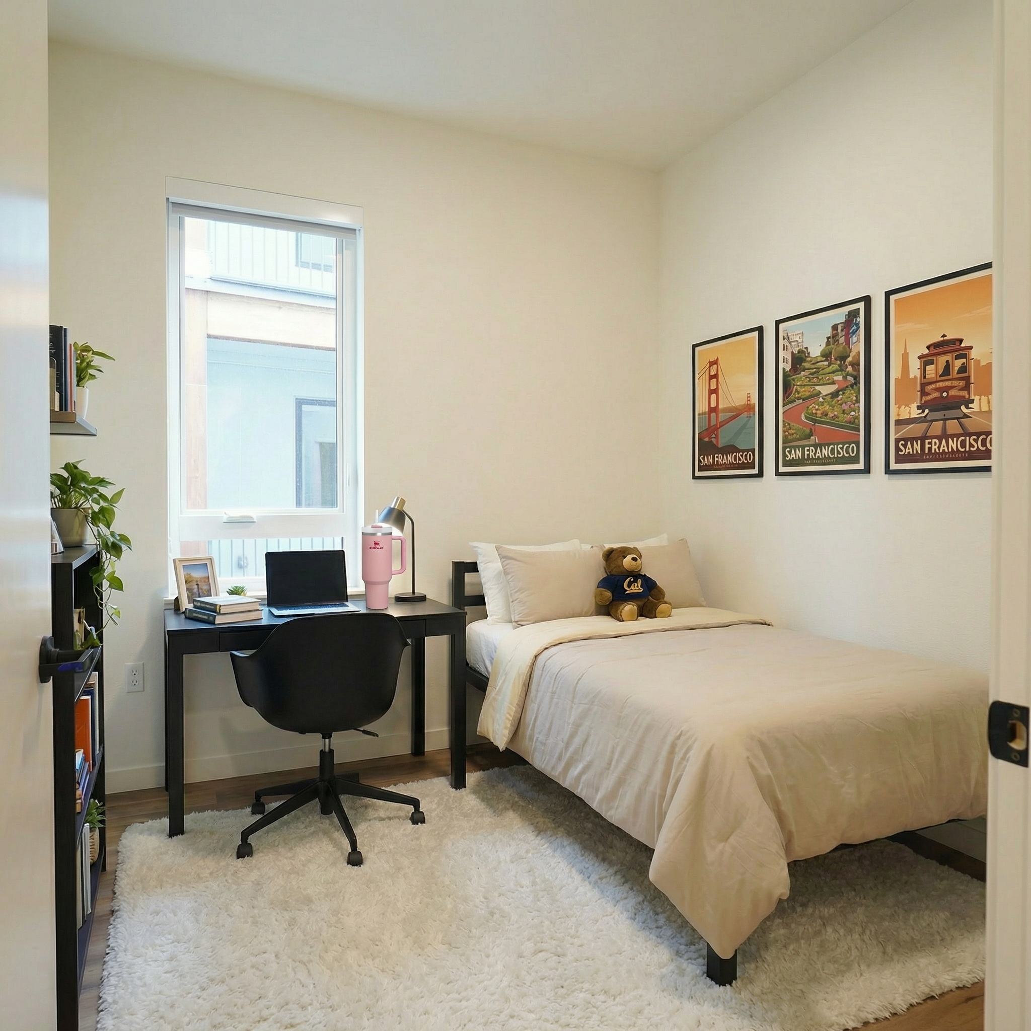 Fully furnished apartment bedroom featuring a bed, a dedicated desk area, and large window at ArtHaus Dwight in Berkeley, CA.