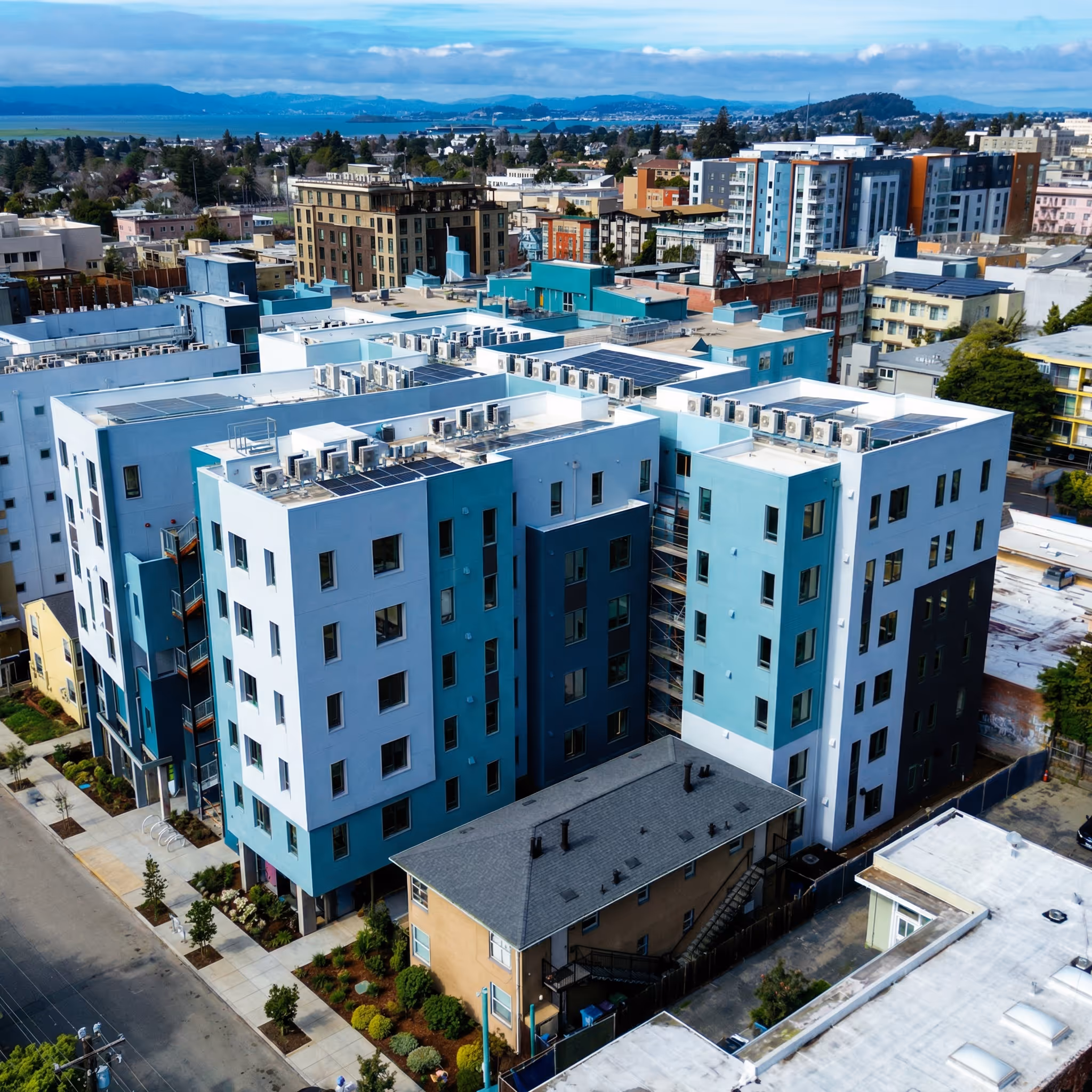 The exterior of ArtHaus Dwight, a multi-story modern apartment building with beige, white and blue sidings