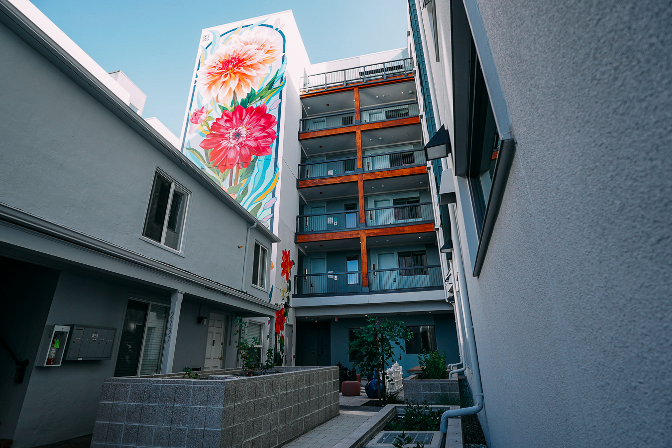 The exterior of ArtHaus Dwight, a multi-story modern apartment building with beige, white and blue sidings