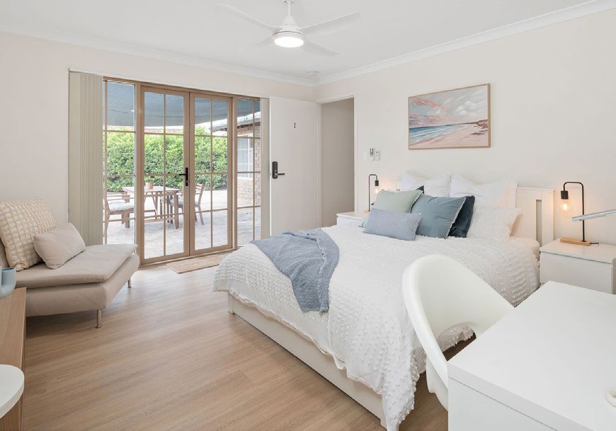 Styled private studio with queen bed, lounge chair and desk