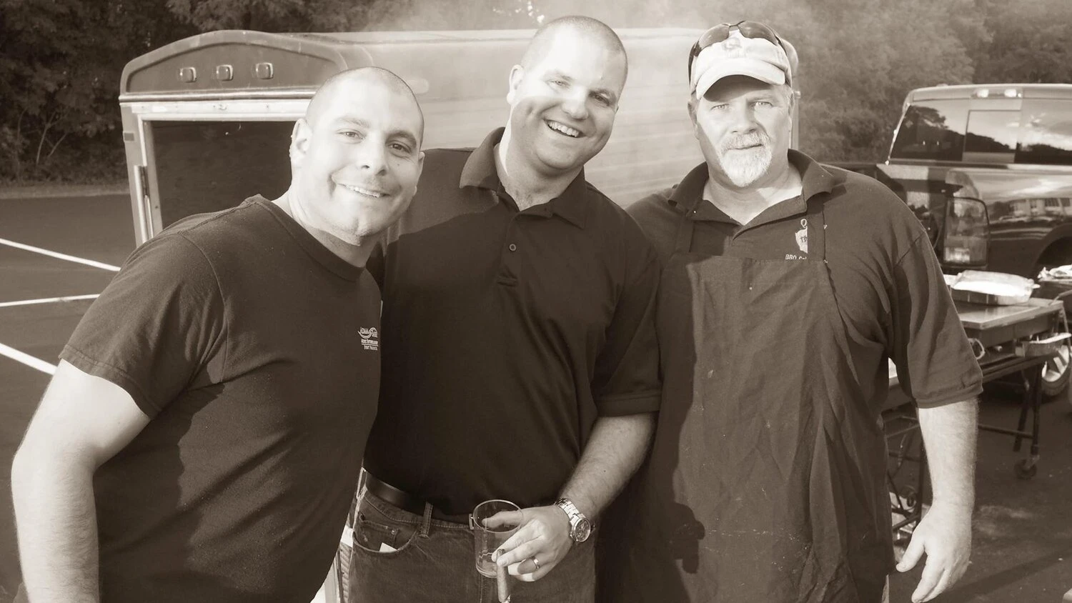 3 men standing together at an event