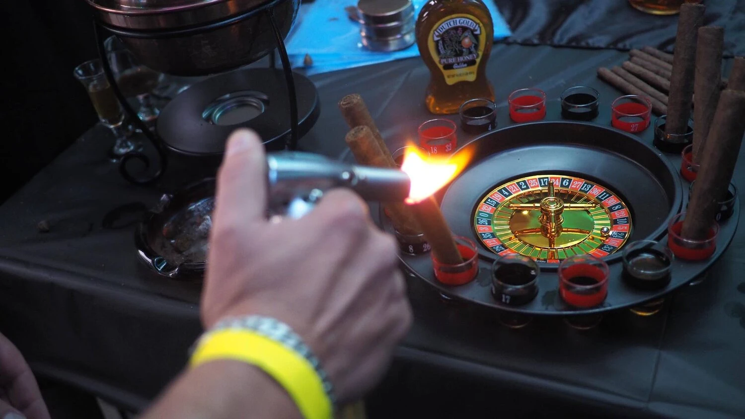 a person holding a small torch lighting a cigar