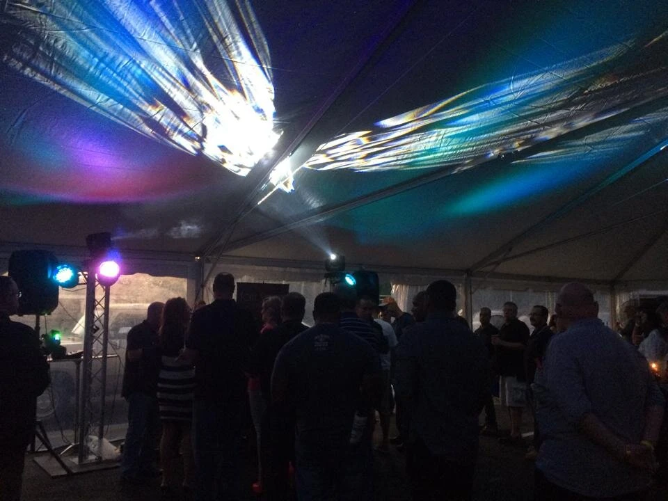 night time view of people under a tent talking