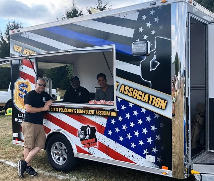  a perosn stands next to an aberdeen pba information truck